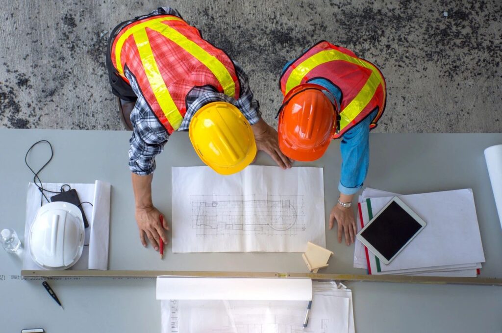 Two workers designing a layout